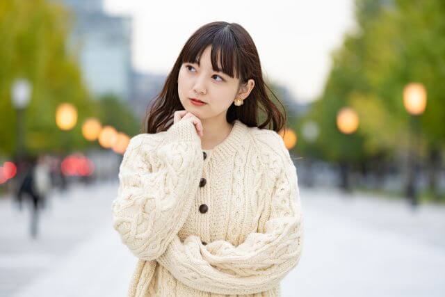 外で何かを考えている女性